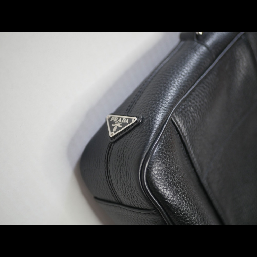 Men’s black leather Prada briefcase with strap.